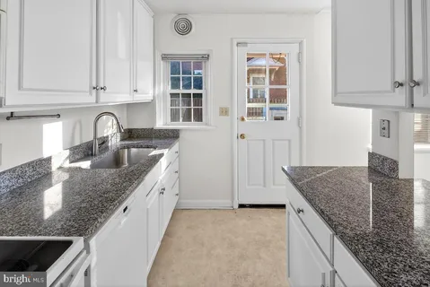 a kitchen with granite countertop a sink and a granite counter tops