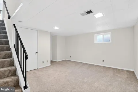 a view of an empty room with stairs
