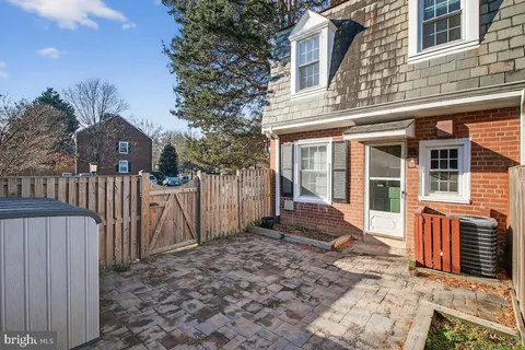a view of a house with wooden fence