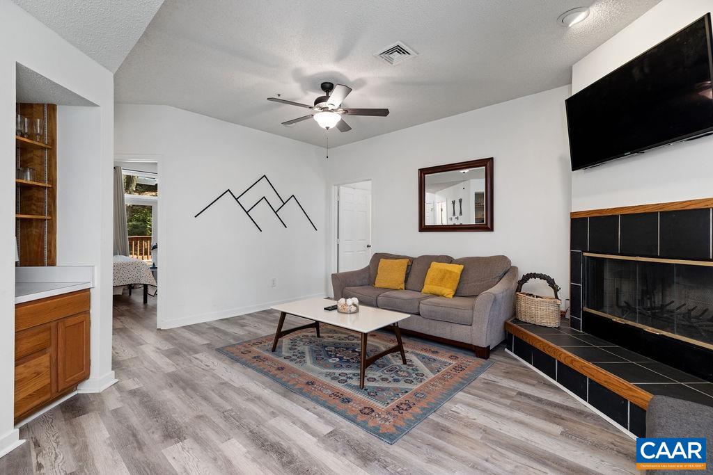2013 Stone Rdg Wds Roseland, VA 22967 - Photo 7 of 24 a living room with furniture a flat screen tv and kitchen view