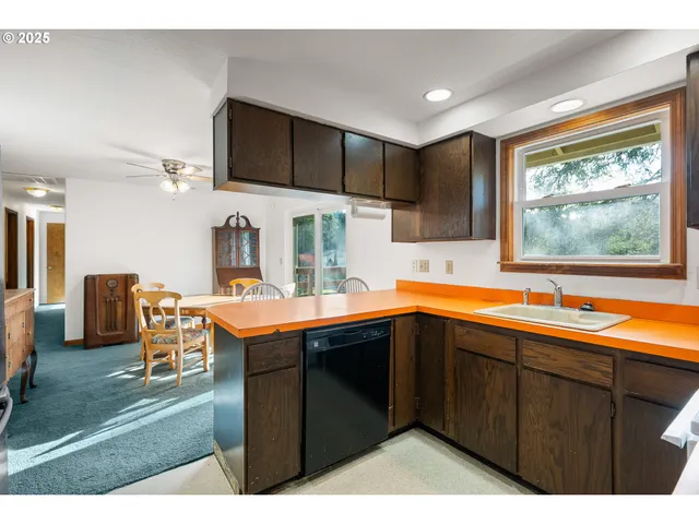 a kitchen with stainless steel appliances kitchen island granite countertop a sink and cabinets