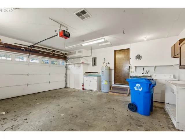 a kitchen with stainless steel appliances kitchen island granite countertop a refrigerator and a sink