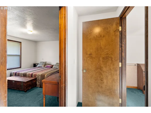 a bedroom with a bed and a mirror