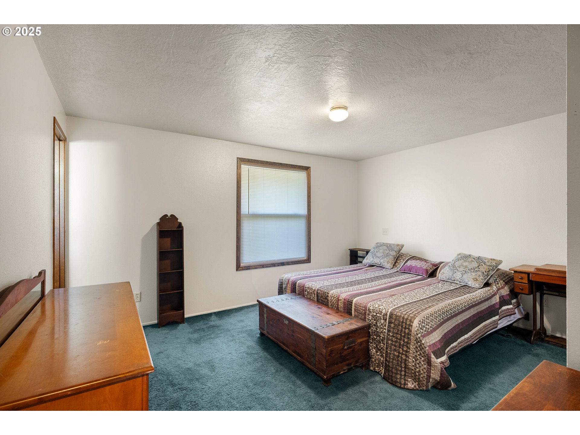 1521 Ranch Road Reedsport, OR 97467 - Photo 23 of 44 a bedroom with a bed and a flat screen tv