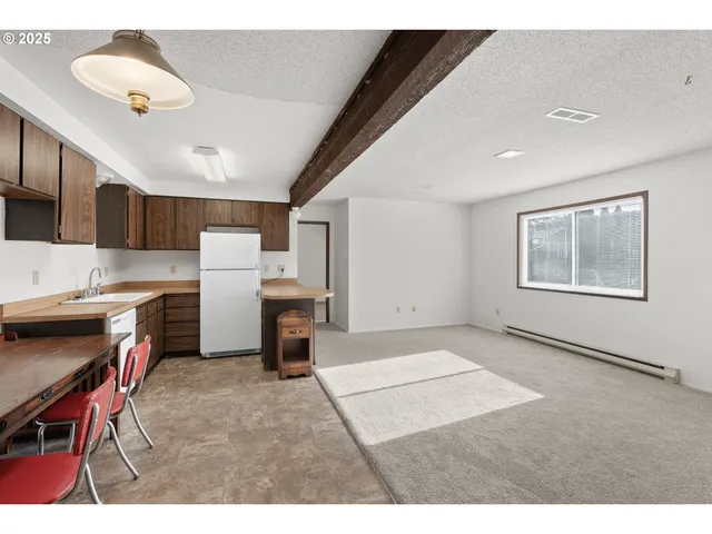 a kitchen with a sink a refrigerator and cabinets