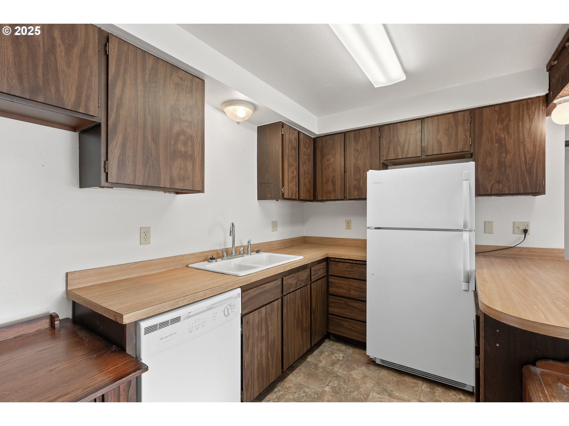 1521 Ranch Road Reedsport, OR 97467 - Photo 38 of 44 a kitchen with a sink a refrigerator and cabinets