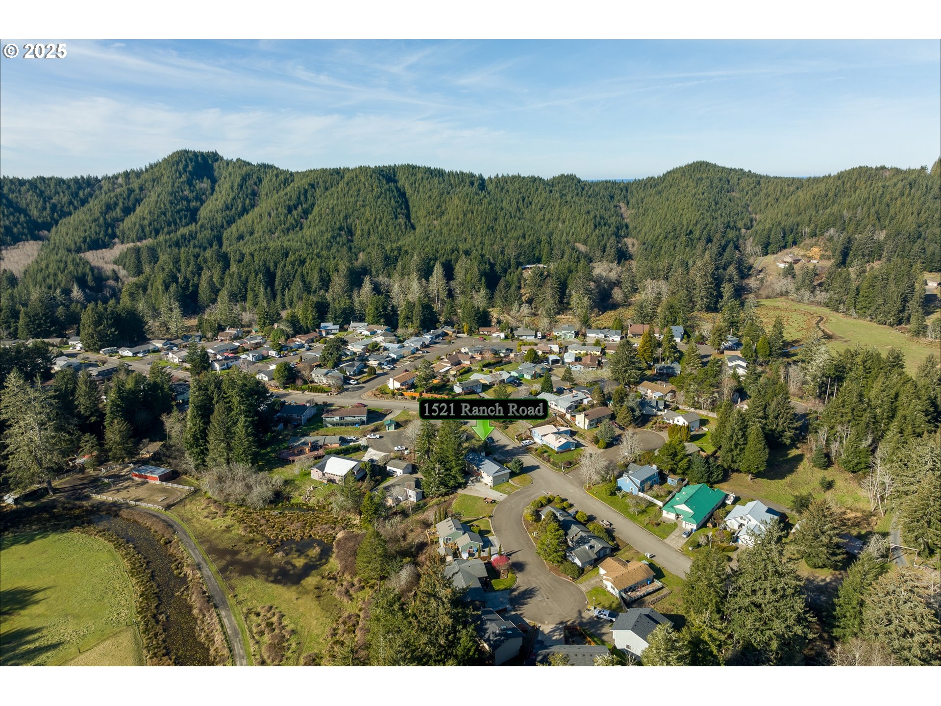 1521 Ranch Road Reedsport, OR 97467 - Photo 43 of 44 a view of a town with mountains in the background