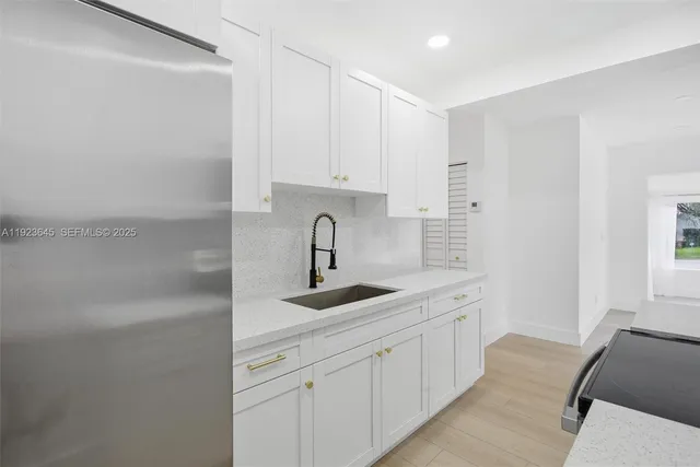 a kitchen with a sink and cabinets