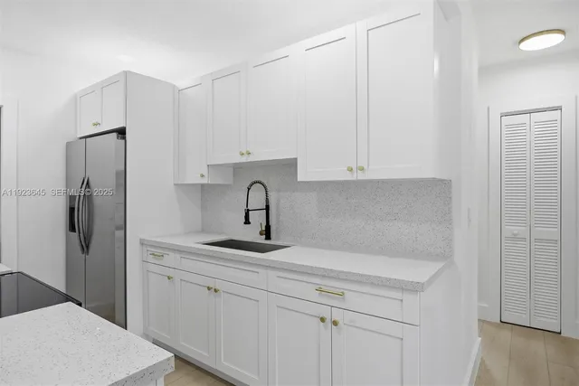 a kitchen with stainless steel appliances white cabinets and a granite counter tops