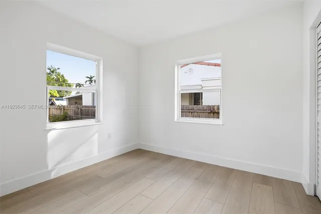 an empty room with wooden floor