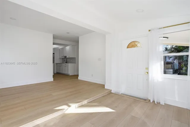 a view of a kitchen with a sink and a refrigerator