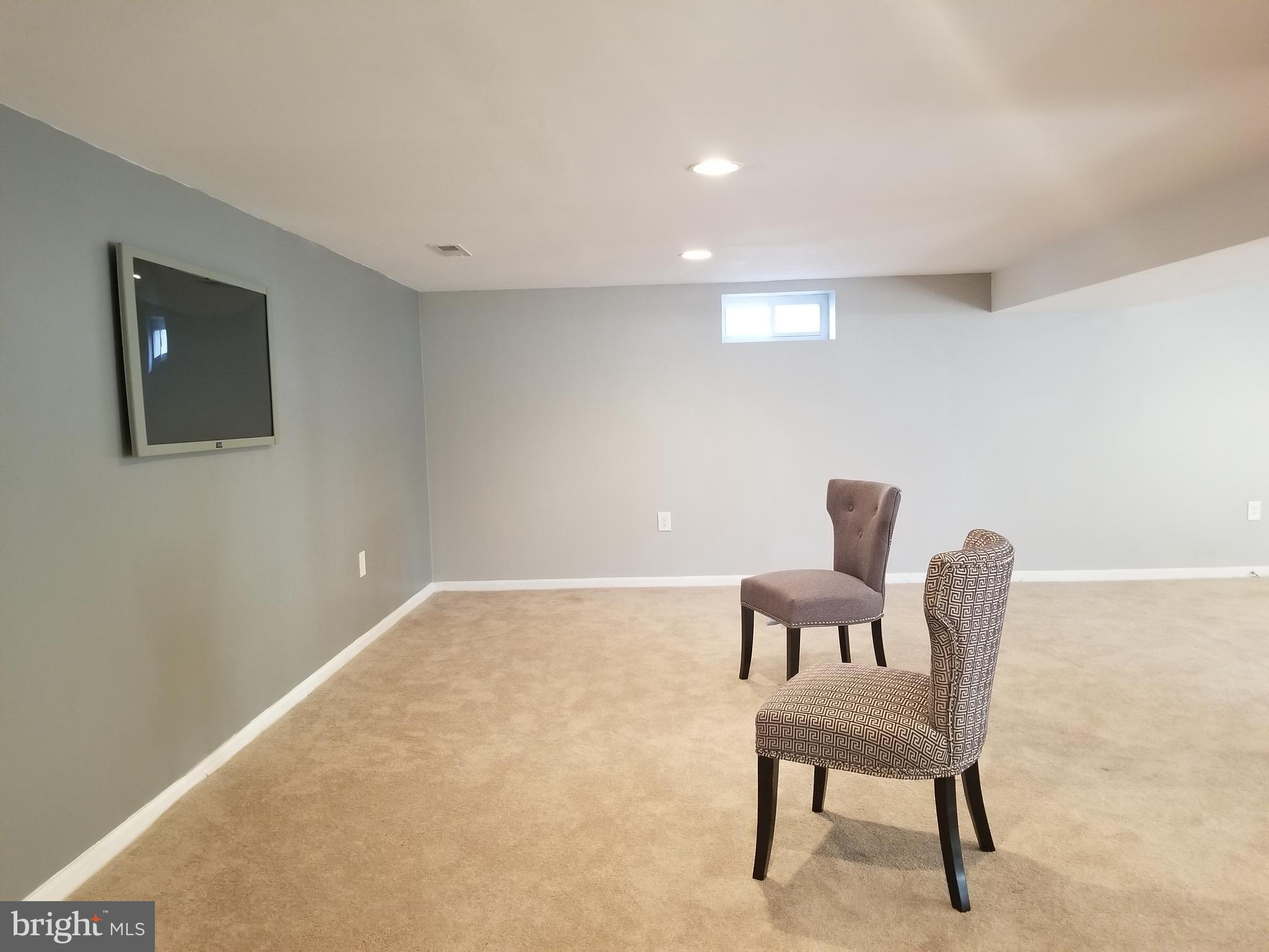 3704 Cassen Road Randallstown, MD 21133 - Photo 14 of 15 a hallway with a chair and a couch