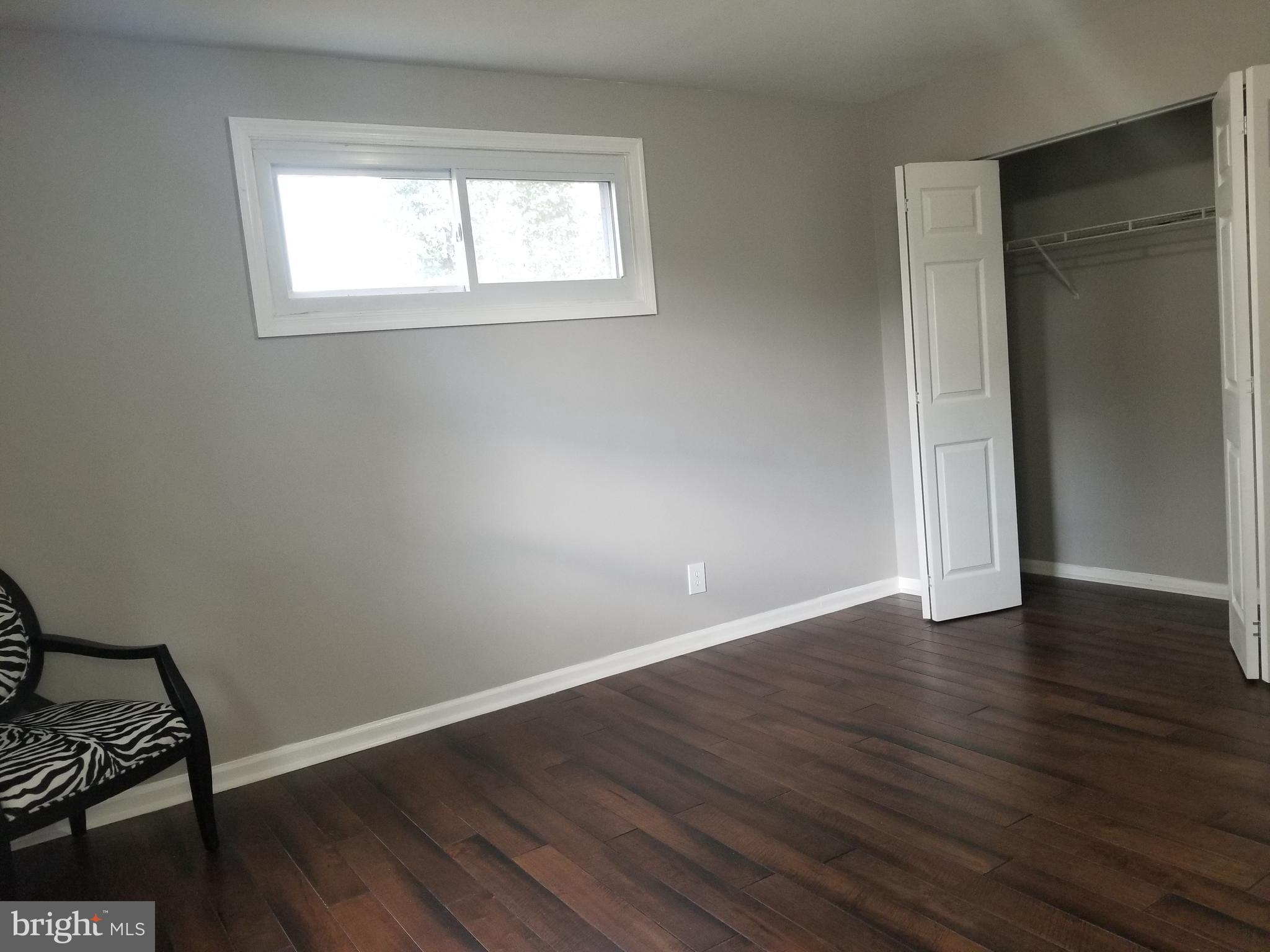 3704 Cassen Road Randallstown, MD 21133 - Photo 8 of 15 an empty room with wooden floor and windows