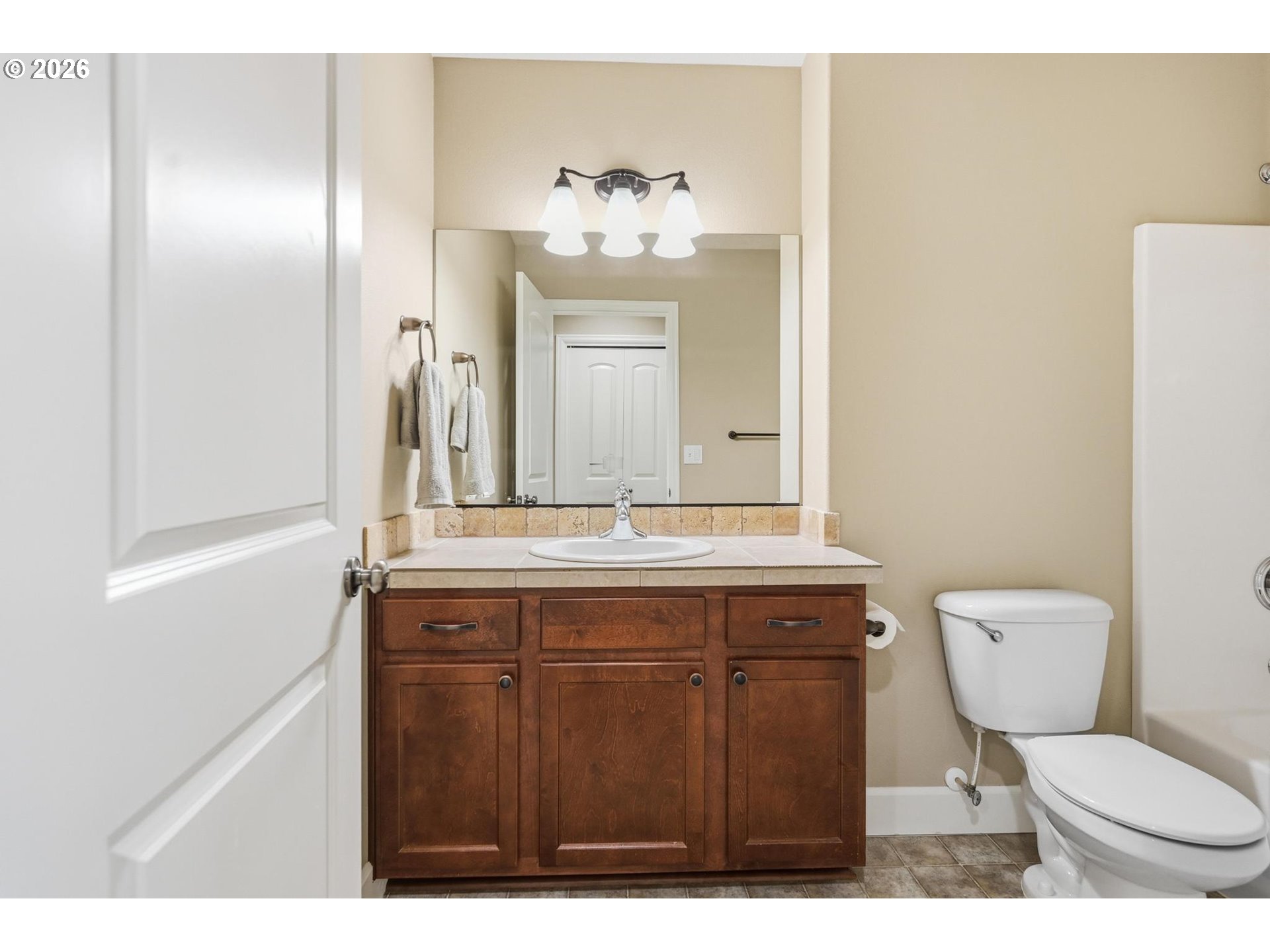 1075 Sage Street Silverton, OR 97381 - Photo 10 of 46 a bathroom with a toilet a sink and mirror