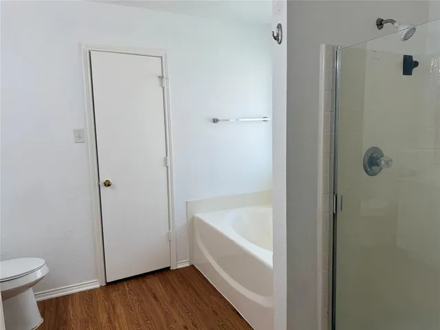 a bathroom with a bathtub and a toilet