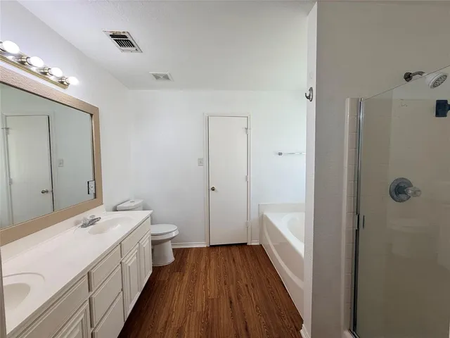 a bathroom with a double vanity sink and mirror with shower