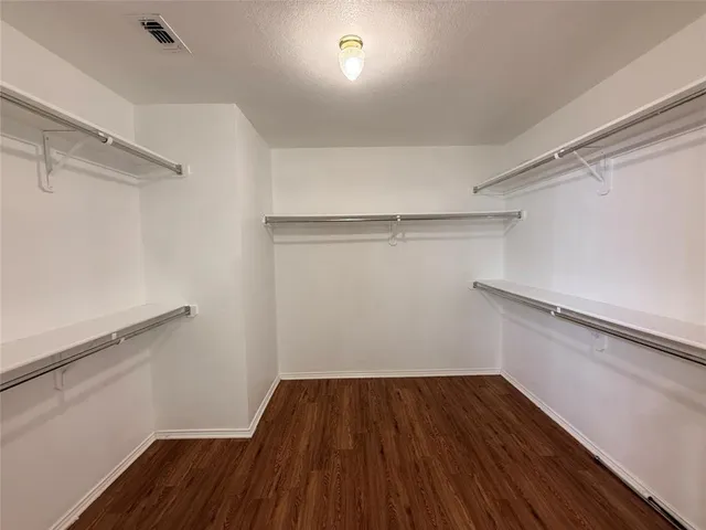 a view of a room with wooden floor