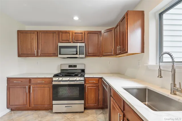 a kitchen with sink a microwave and cabinets