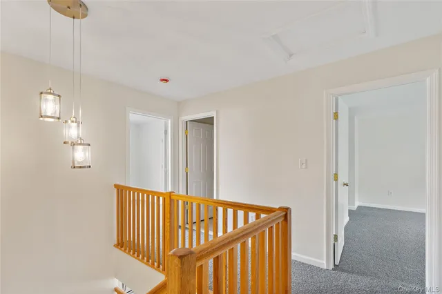 a view of a hallway to a house with wooden floor