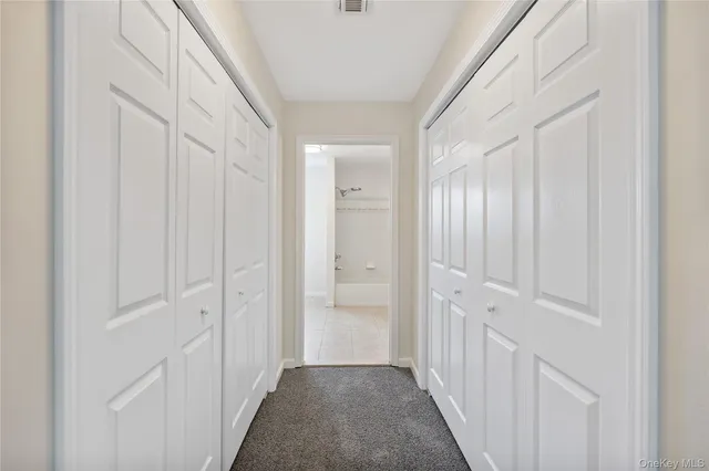 a view of a hallway with white doors