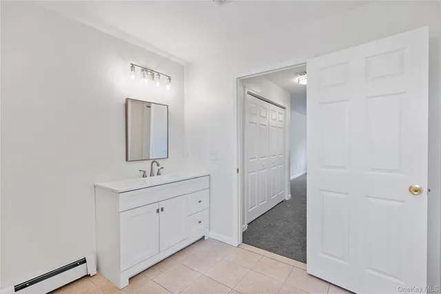 a bathroom with a double vanity sink a mirror and a shower