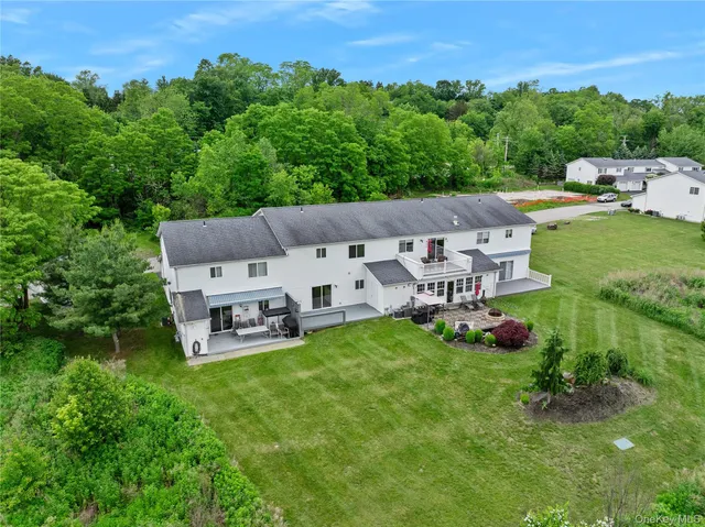 an aerial view of a house with garden space and street view