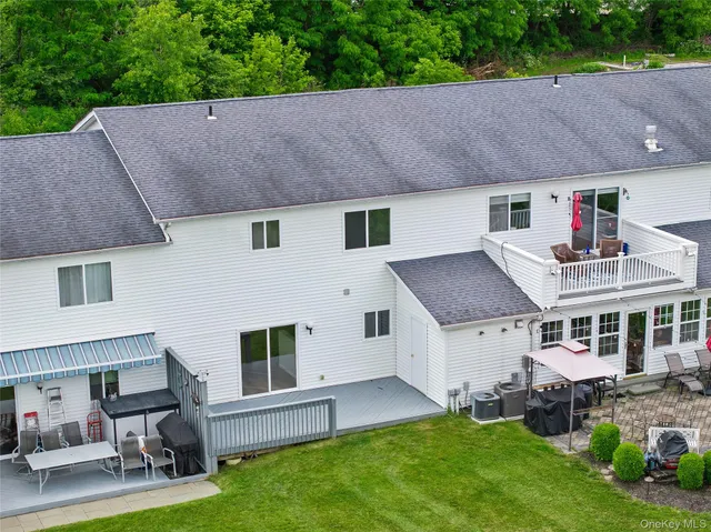 a aerial view of a house with a yard deck and a slide