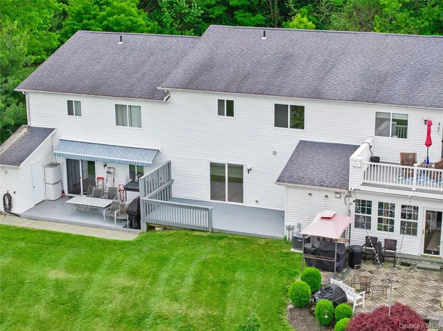 a aerial view of a house with a yard patio and fire pit
