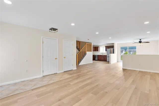 a view of a kitchen with a sink and a refrigerator