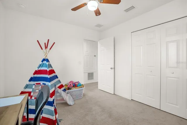 an room with toys and ceiling fan