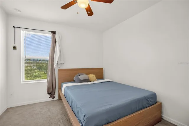 a bedroom with a bed and window