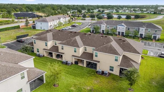 an aerial view of residential houses with outdoor space