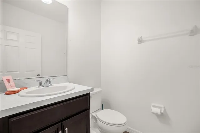 a bathroom with a sink a toilet and mirror