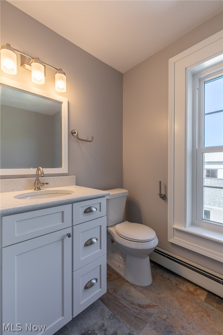 7585 Branch Road Medina, OH 44256 - Photo 23 of 35 Here's the updated main bath on the 2nd floor of the main house. Just like elsewhere in the home, it has the same new tile floors, new Shaker-style vanity with quartz countertop, new window, new lighting & hardware, etc.