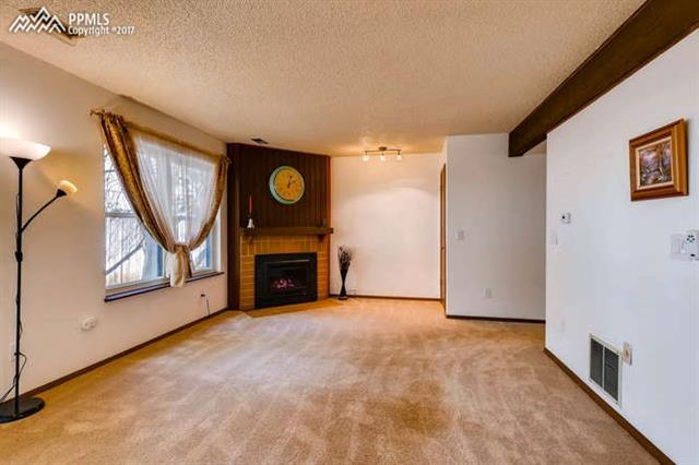 4737 Barnes Road Colorado Springs, CO 80917 - Photo 3 of 11 Open living room with newly converted fireplace with remote control