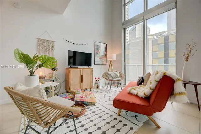 a living room with furniture fireplace and flat screen tv
