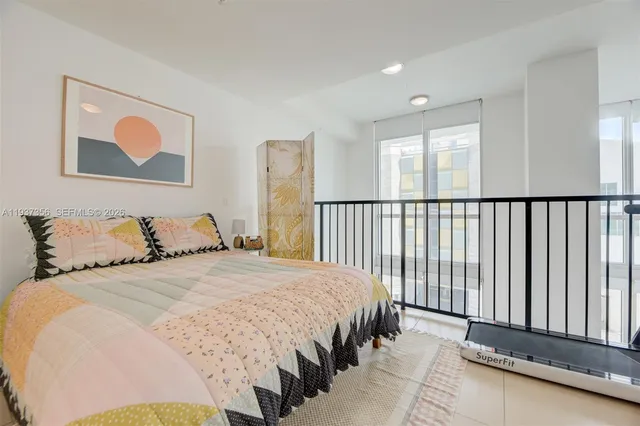 a bedroom with a bed and a large window