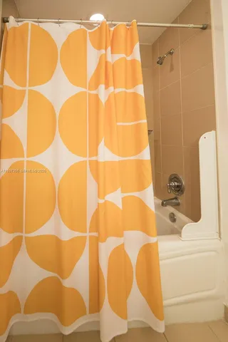 a bathroom with a bathtub and shower