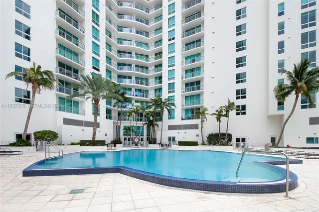 a view of a tall building with a swimming pool