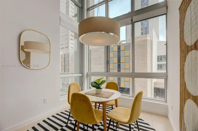 a view of a dining room with furniture a chandelier and wooden floor