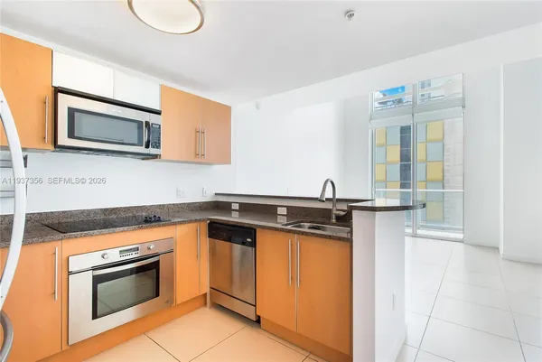a kitchen with a stove microwave and sink