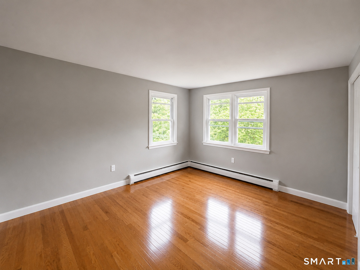 341 Harland Road Norwich, CT 06360 - Photo 13 of 29 an empty room with wooden floor and windows