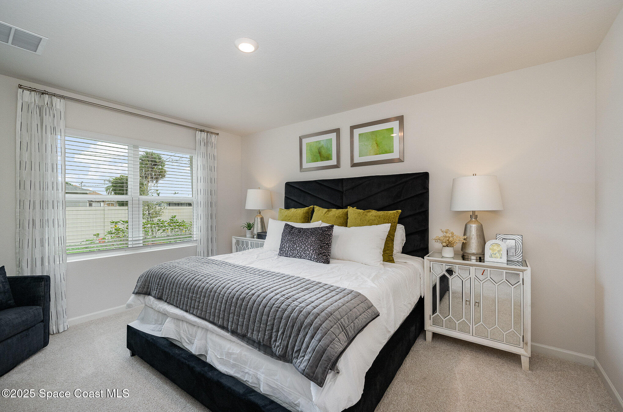 591 Topeka Road Southwest Palm Bay, FL 32908 - Photo 20 of 34 a bedroom with a bed and a window