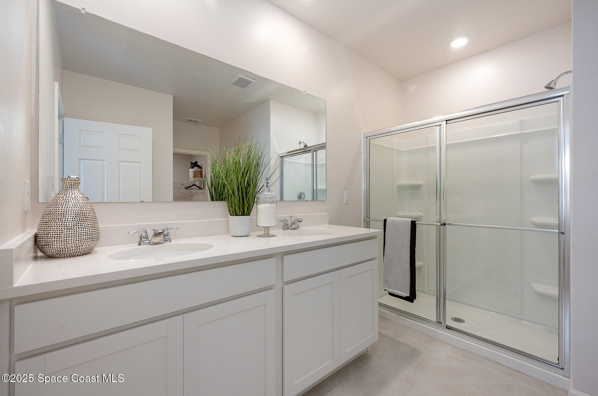 591 Topeka Road Southwest Palm Bay, FL 32908 - Photo 22 of 34 a bathroom with a double vanity sink mirror and shower