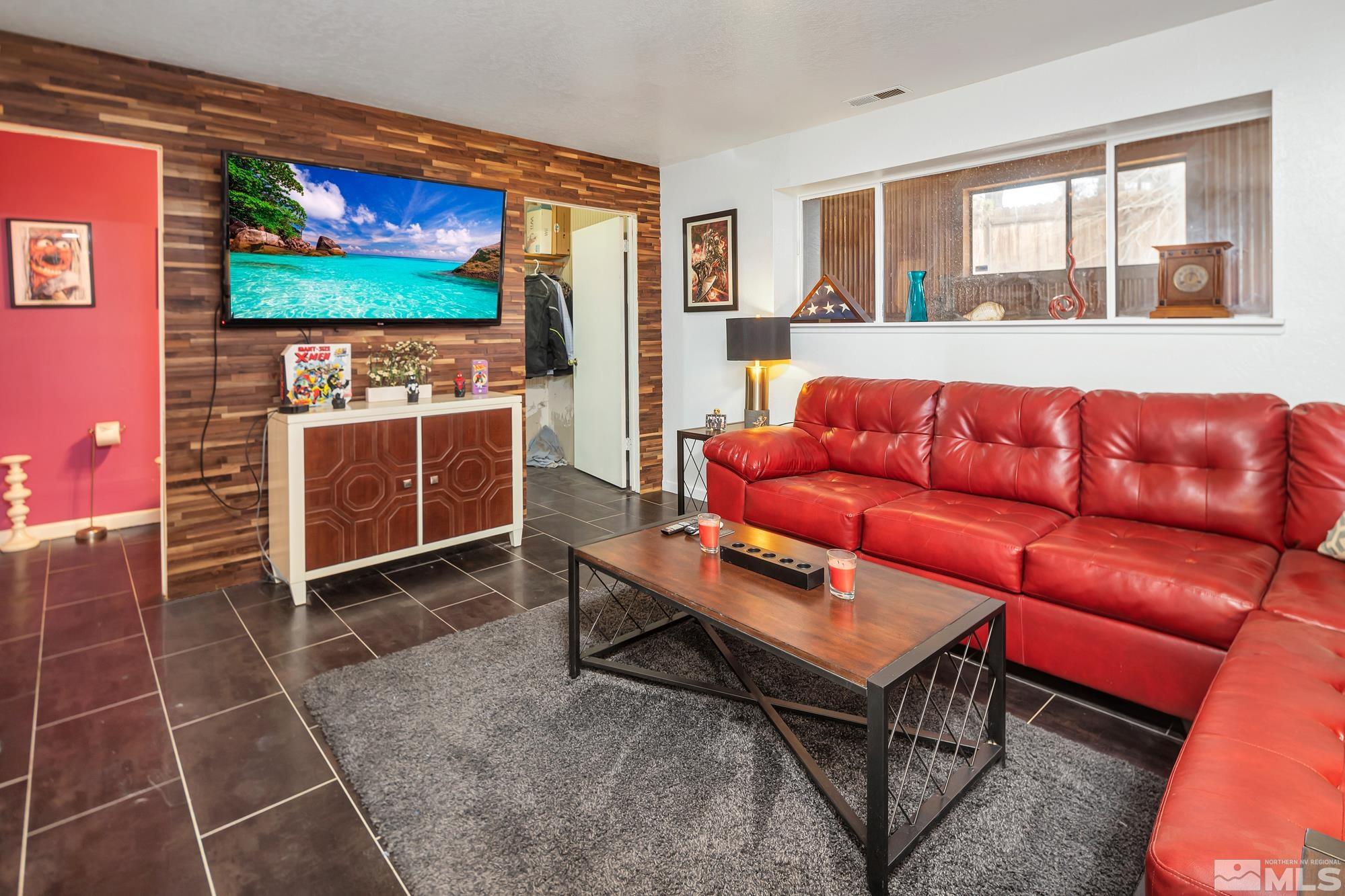 3435 Bowie Road Reno, NV 89503 - Photo 13 of 22 a living room with furniture a flat screen tv and a fireplace