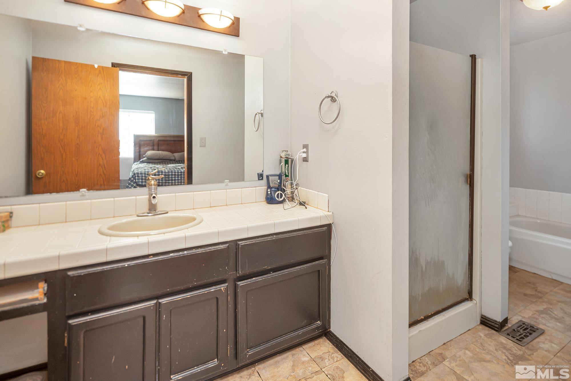 3435 Bowie Road Reno, NV 89503 - Photo 16 of 22 a bathroom with a sink and a mirror