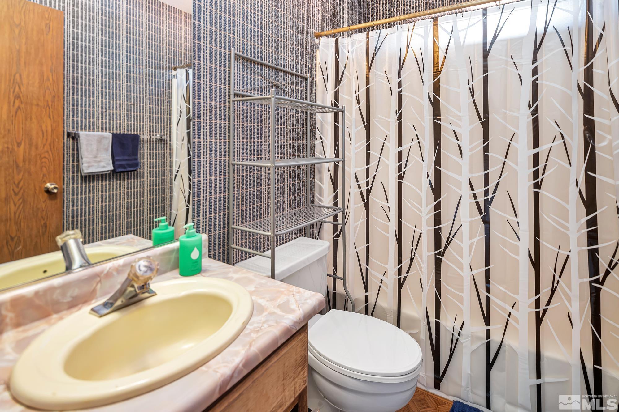 3435 Bowie Road Reno, NV 89503 - Photo 17 of 22 a bathroom with a granite countertop sink and a mirror