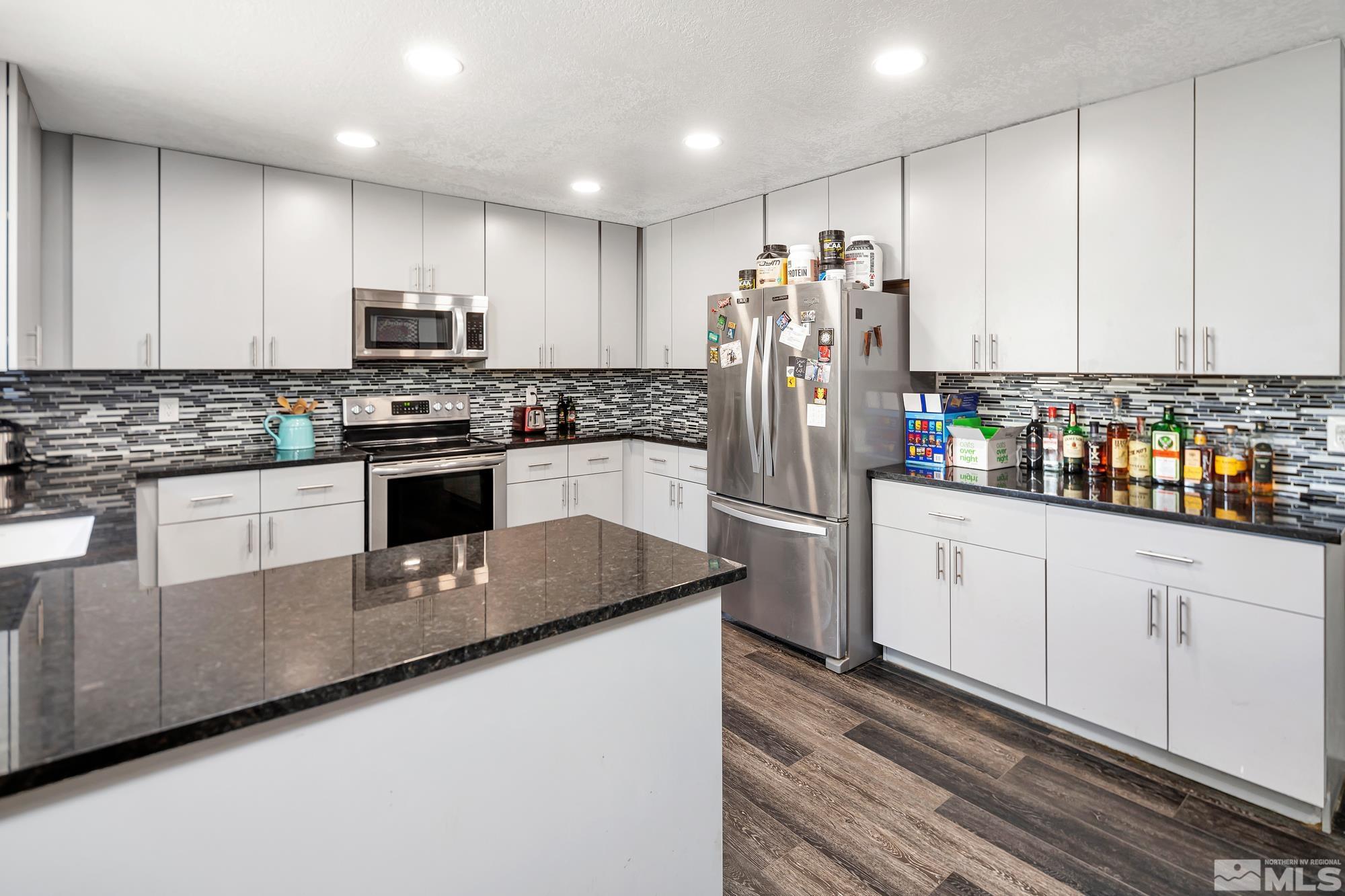 3435 Bowie Road Reno, NV 89503 - Photo 6 of 22 a kitchen with stainless steel appliances granite countertop a refrigerator sink and stove