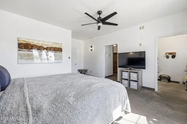 a bedroom with a bed and a flat screen tv