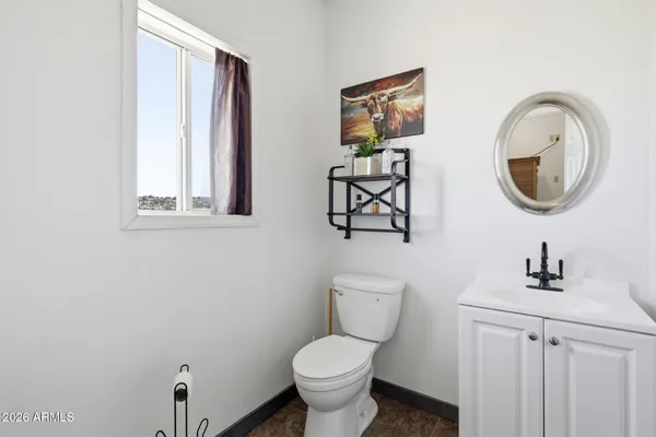 a bathroom with a toilet a sink and a mirror